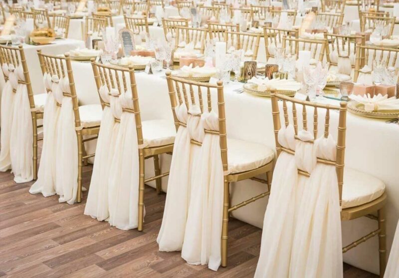 Gold Chiavari Chair with White Cushion in Wedding Dining Setting