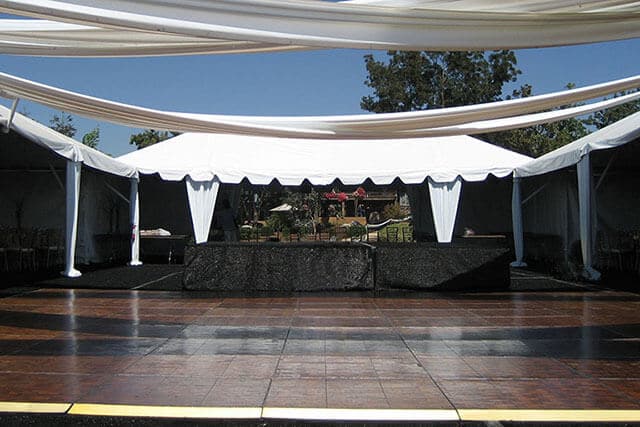 outdoor stage with dance floor and tenting