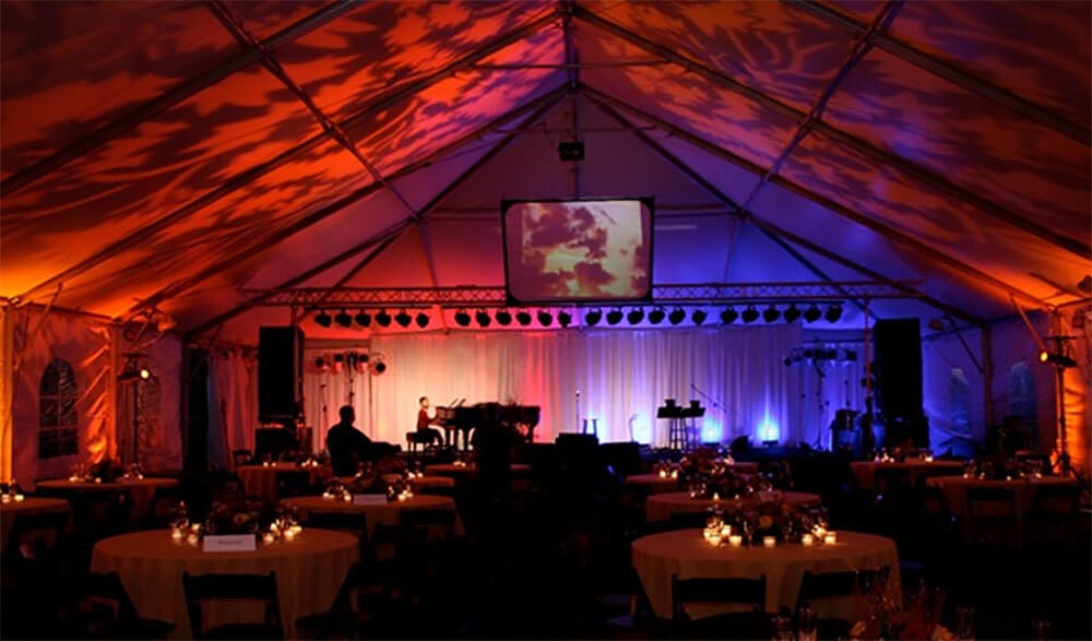 large party tent interior with concert stage and lighting