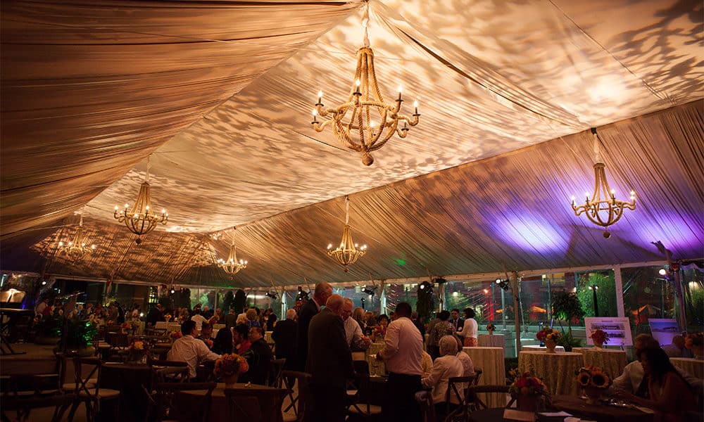 outdoor winter wedding reception under tent with dramatic party lighting