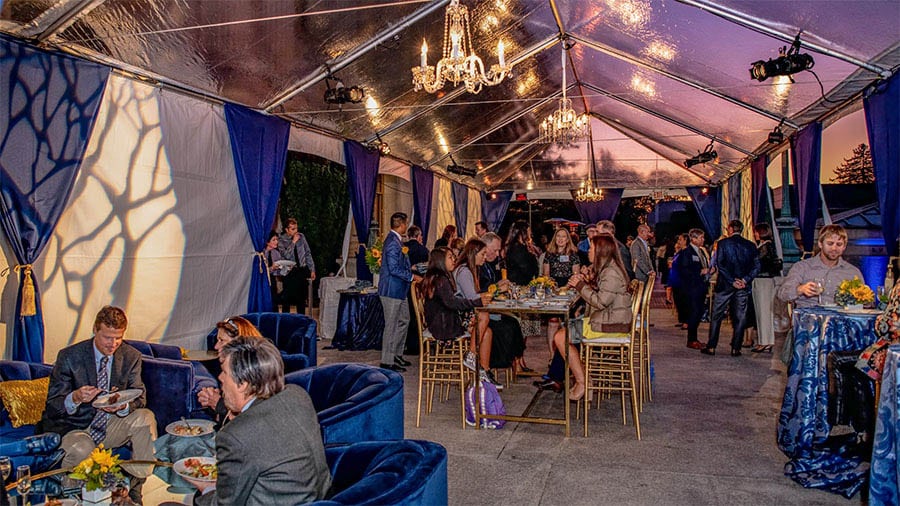 Outdoor Event Inside Clear Tent with Food Service 10 party planning tips outdoor with tenting guests at tables with food service