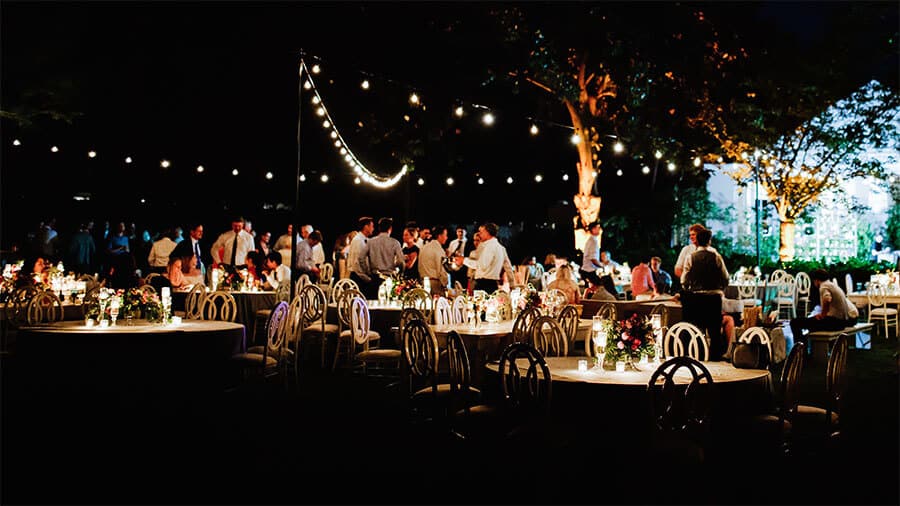 Evening Semi-Formal Event with String Lighting 10 party planning tips outdoor evening event string lighting table decorations guests