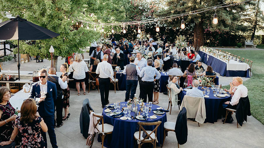 Outdoor Wedding Reception with Table Settings and String Lighting 10 party planning tip outdoor wedding reception cocktails with guests