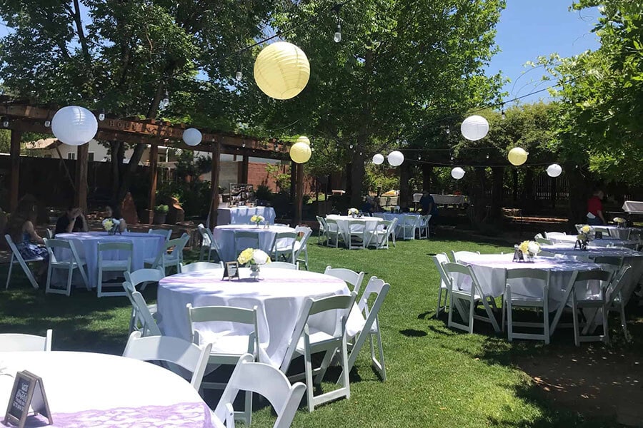outdoor graduation party with tables chairs balloons