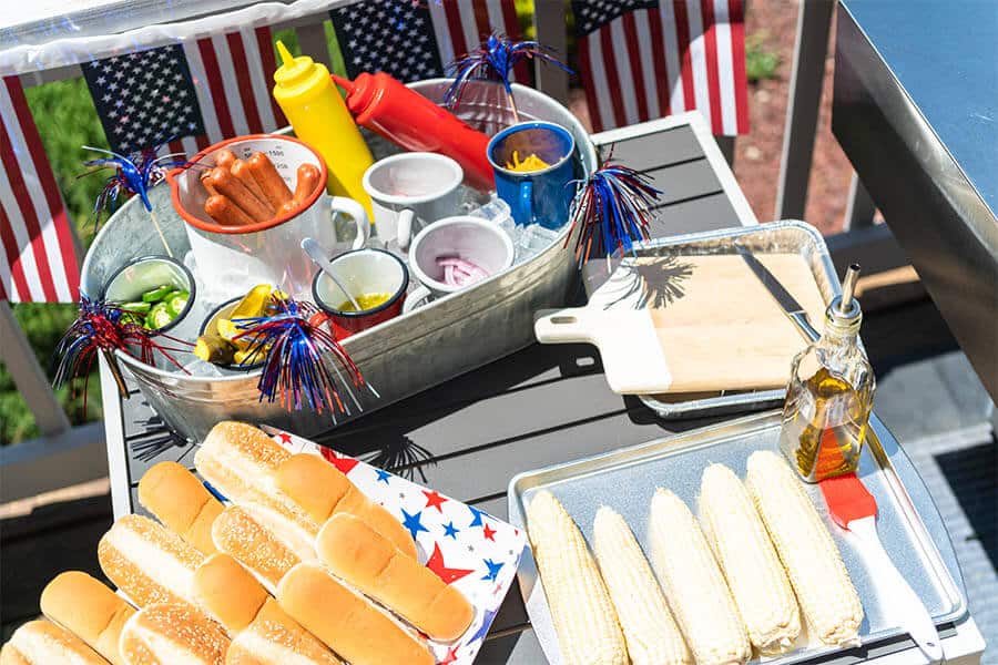 assortment of bbq foods and condiments for 4th of july themed party
