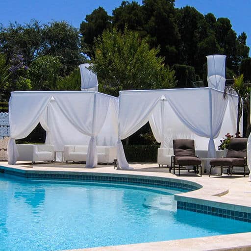 two large cabanas next to swimming pool