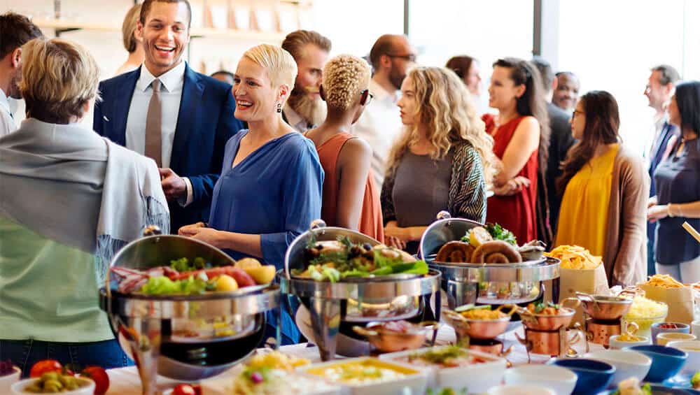 crowd of attendees casually mingling at corporate event