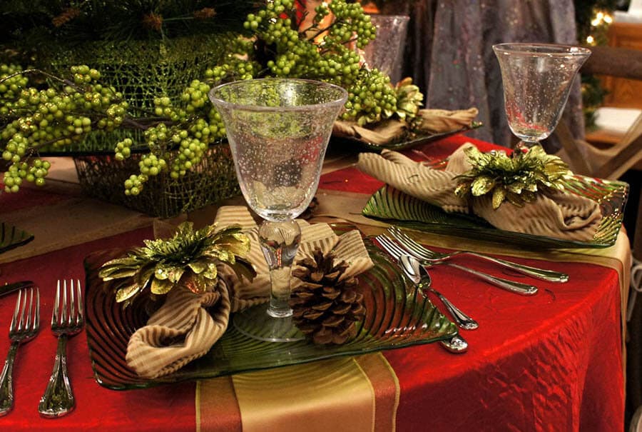 christmast themed table setting with elegant red and gold linens and tablecloth
